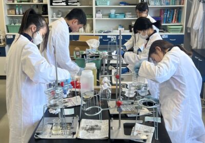 Students conducting an experiment to compare how effectively different filtering materials clean polluted water.